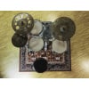 Drum kit with cymbals on oriental rug for drumming practice or performance.