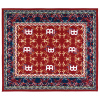 Small oriental-style drum rug with intricate red, blue, and gold patterns.