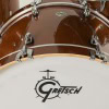 Close-up of a bronze sparkle drum shell with Gretsch logo.