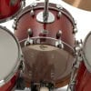 Red drum kit with chrome hardware and cymbals for live performance.