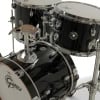Black drum kit with cymbals and hardware for professional drumming.