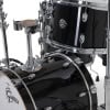 Black drum kit with chrome hardware for jazz music performances.