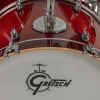 Close-up of a Gretsch Catalina Club drum with red gloss finish and logo.