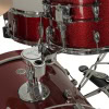 Close-up of a red sparkle drum kit with chrome hardware and cymbals.