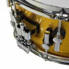 Snare drum with gold sparkle finish, featuring chrome hardware and precise tuning lugs.