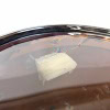 Close-up of a drum with a drumstick and tissue on the surface, highlighting percussion equipment.