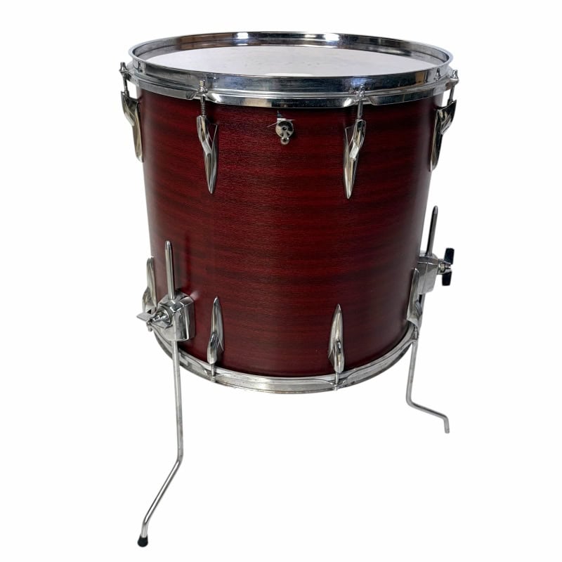 Drum with wooden shell and metal hardware, displayed on a stand, ideal for percussionists and drummi.
