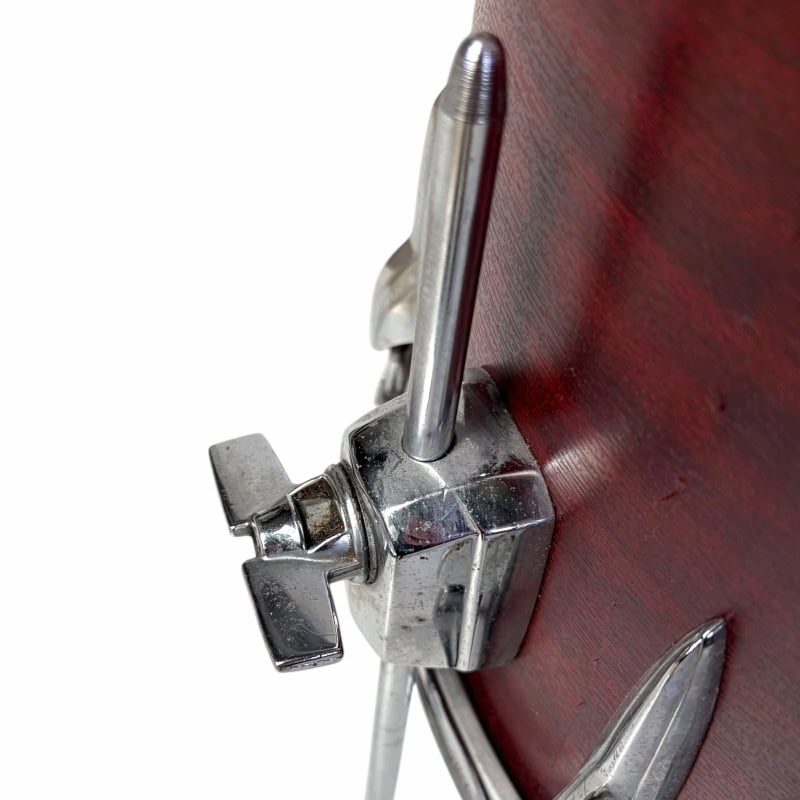 Close-up of Drummers Only logo on a drum kit with chrome hardware and wooden shell.