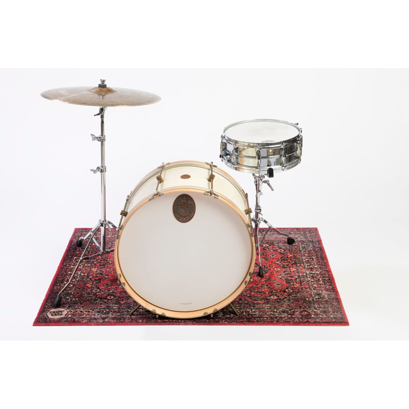 Drum kit with cymbals and snare on decorative rug for drumming practice.