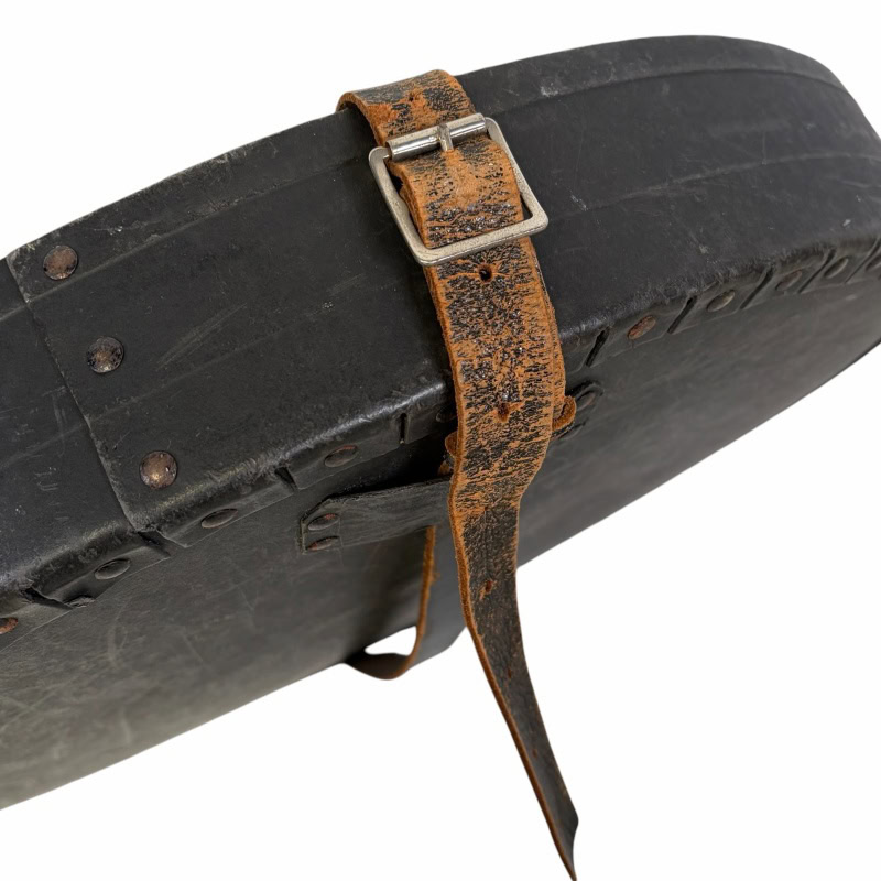 Vintage cymbal case with worn leather strap and metal buckle, ideal for protecting cymbals during tr.