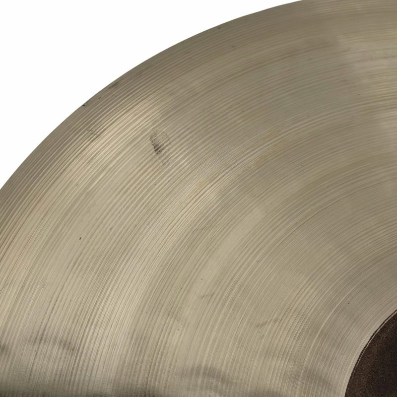Close-up of a cymbal used in drumming and percussion performances.