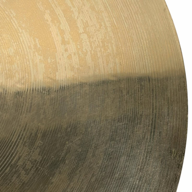 Close-up of a drumstick with drum kit in the background, perfect for drumming enthusiasts.
