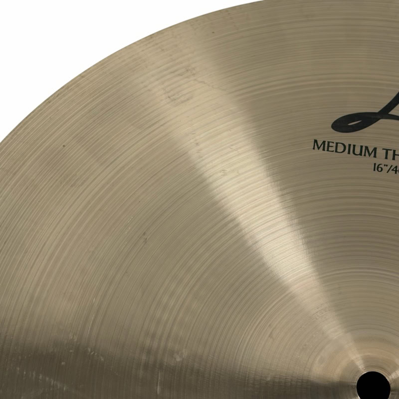 Cymbal close-up showing detailed grooves and branding, ideal for drumming and percussion enthusiasts.