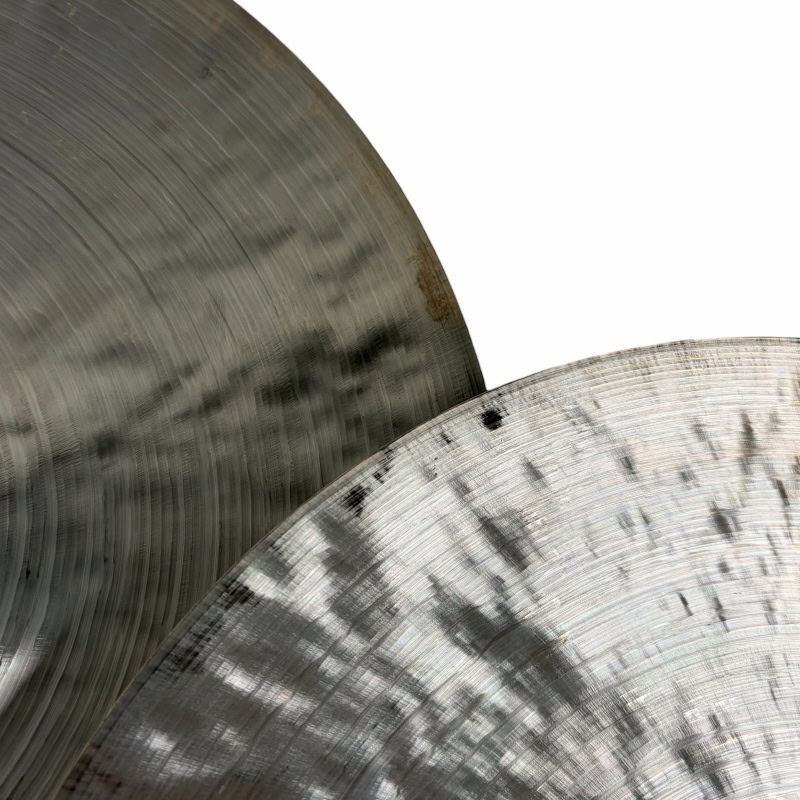 Cymbals used by professional drummers, showcasing their shiny, textured surfaces. Perfect for drum k.