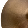 Close-up of a bronze cymbal for drumming, showing detailed surface texture.