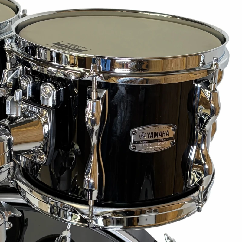 Yamaha black snare drum with chrome hardware, close-up shot.