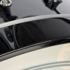 Close-up of Drummers Only logo on a black drum kit with minor surface scratches.