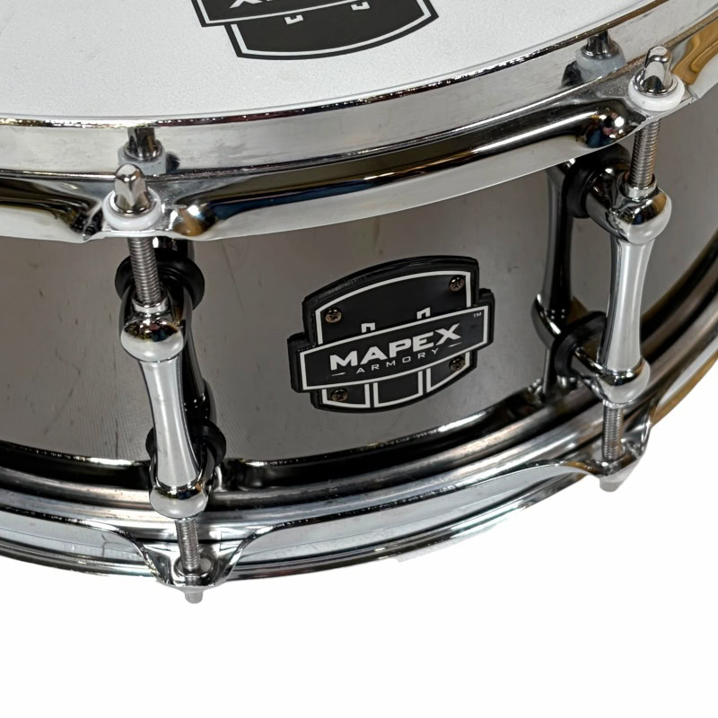 Close-up of a silver drum with Drummers Only logo and Mapex badge.