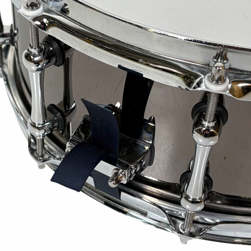 Close-up of a snare drum with drumsticks and hardware, perfect for drumming enthusiasts.