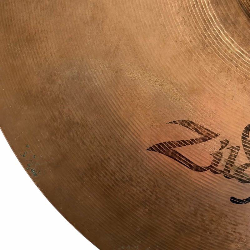 Close-up of a bronze cymbal with detailed grooves, perfect for drummers and percussion enthusiasts.