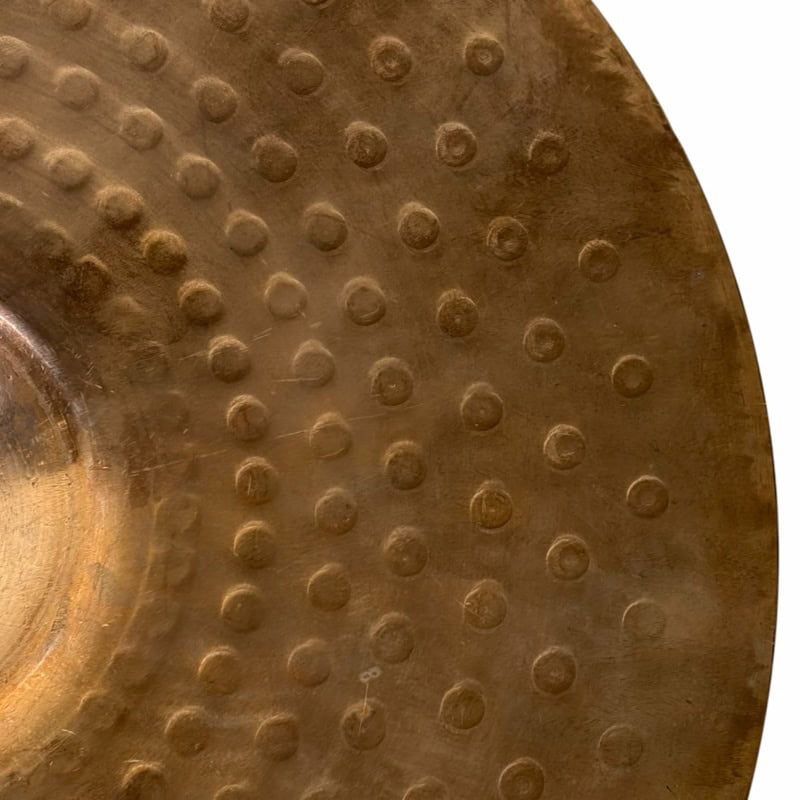 Close-up of a traditional wooden Taiko drum with metal studs, used in Japanese drumming performances.