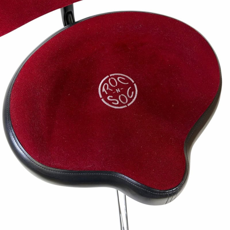 Comfortable red drum throne seat for drummers with black base.