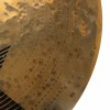 Close-up of a drummer's hand striking a cymbal during a performance.