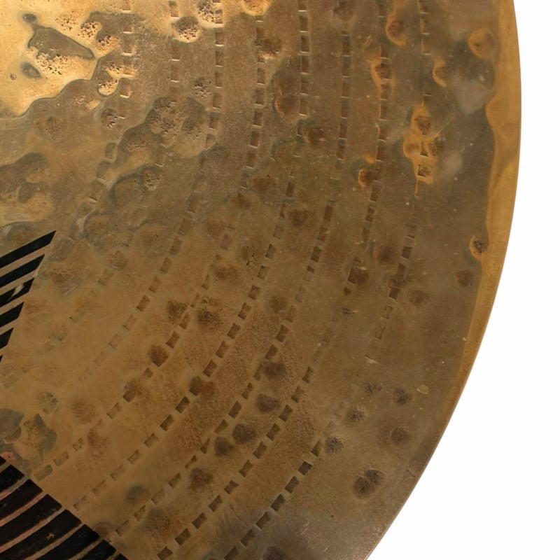 Close-up of a drummer's hand striking a cymbal during a performance.