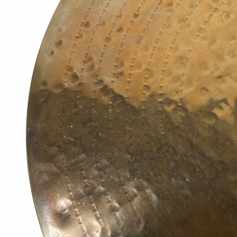 Close-up of a vintage drum surface with textured metal finish.