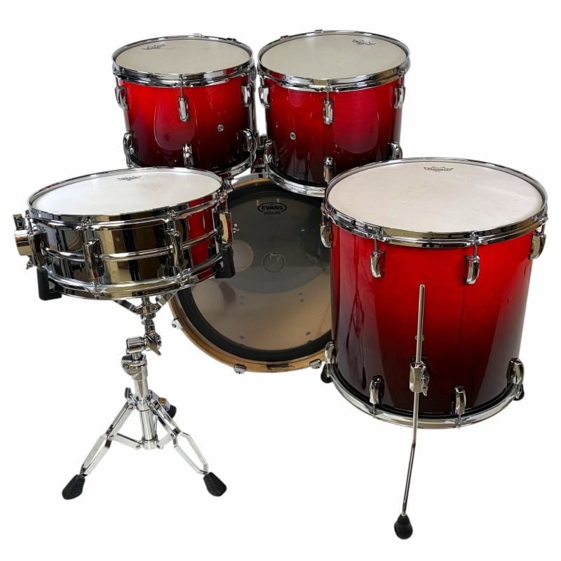 Red drum kit with snare, toms, and cymbals for drummers and percussionists.