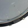 Close-up of a drum practice pad with drumsticks on a white background.