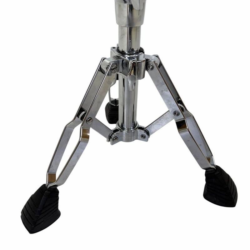 Metal tripod drum stand with rubber feet for stability.