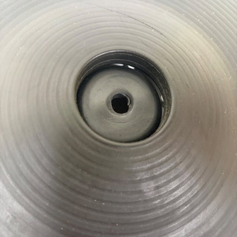 Close-up of drumstick holder inside a drum, showcasing drumstick storage.
