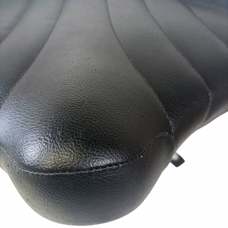 Drum throne seat with black leather upholstery, designed for comfort during drumming sessions.