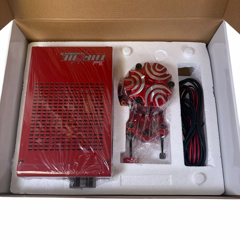 Electronic drum module with red and white swirl design, includes cables and mounting hardware.