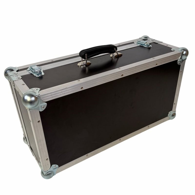 Heavy-duty black equipment case for drummers with metal reinforcements and handle.