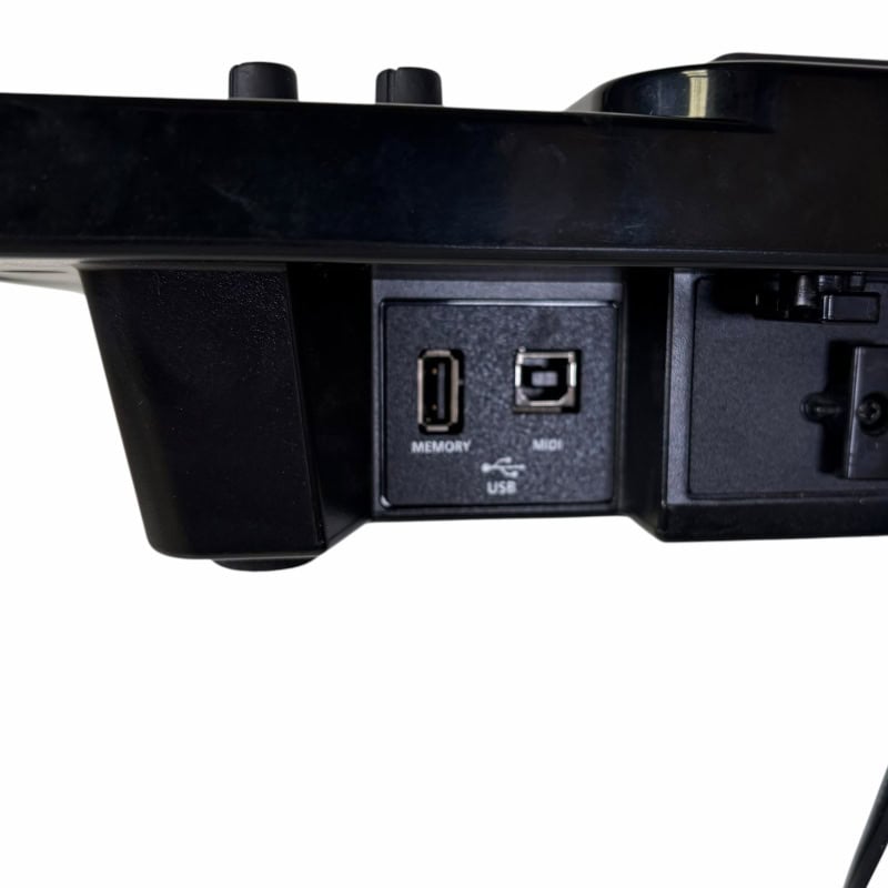 Electronic drum module with USB and memory ports for drumming setup.