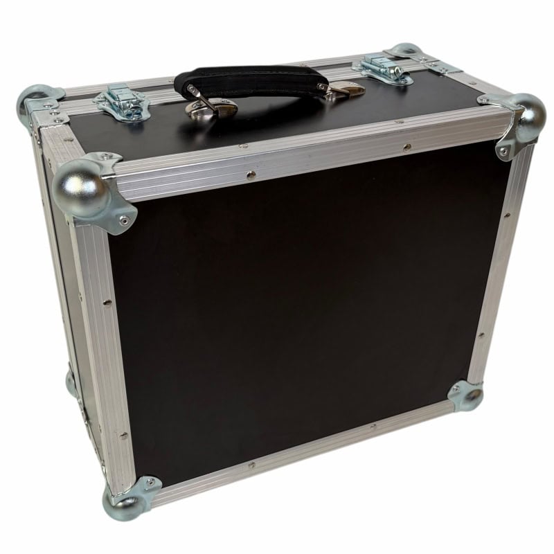 Heavy-duty black equipment case for drummers with metal reinforcements and handle.