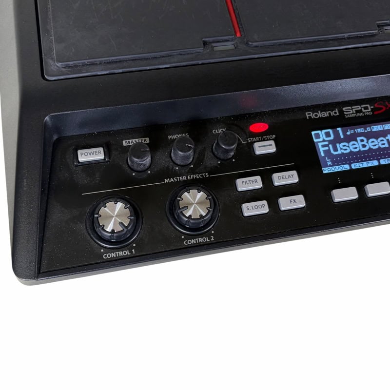Roland electronic drum machine with control knobs and digital display.