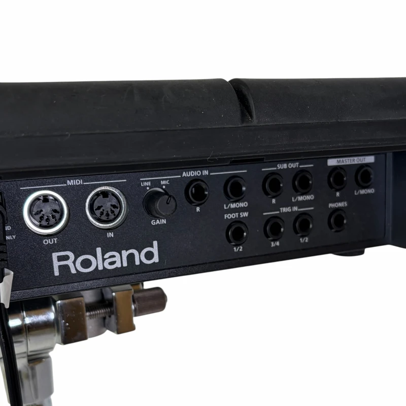 Close-up of Roland electronic drum module with various input and output ports.