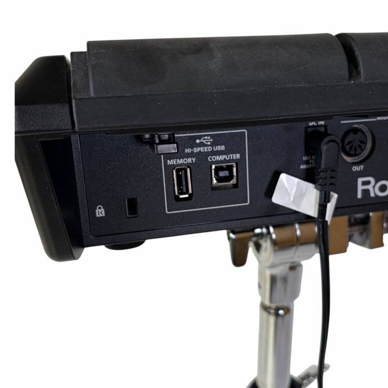 Close-up of electronic drum module with USB and audio ports for drummers.