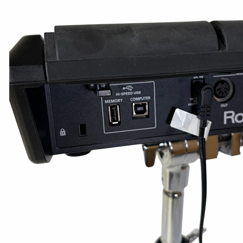 Close-up of electronic drum module with USB and audio ports for drummers.