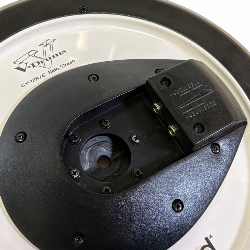 Close-up of drum pedal mount with brand logo and mounting hardware.