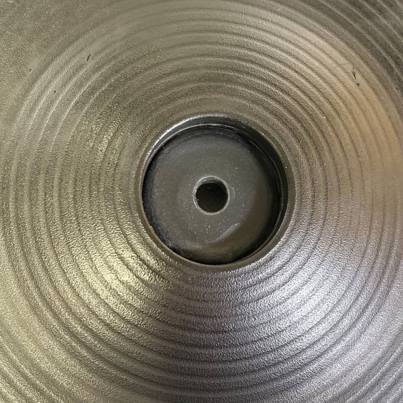 Close-up of a drum practice pad with concentric circles for drumming practice.