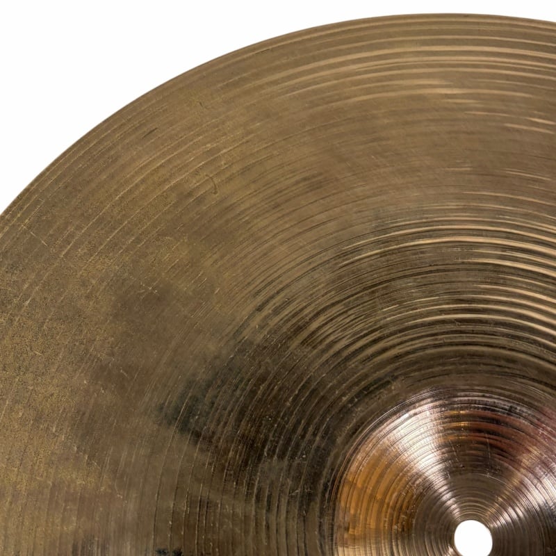 Cymbal of a professional drum kit, highlighting intricate grooves and metallic finish.