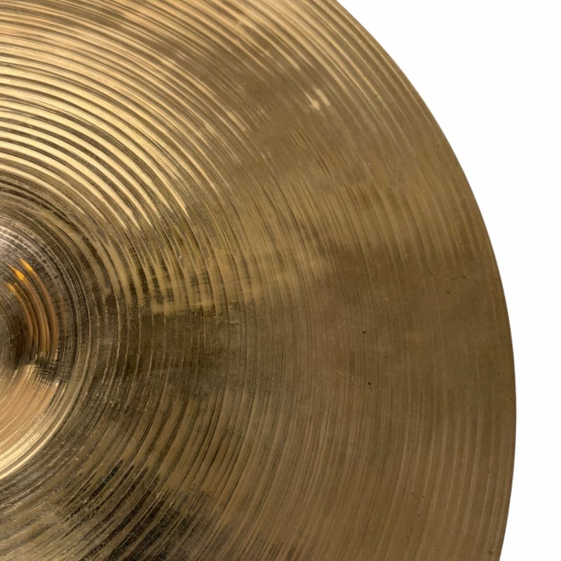 Brass cymbal with detailed grooves, perfect for drummers and percussion enthusiasts.