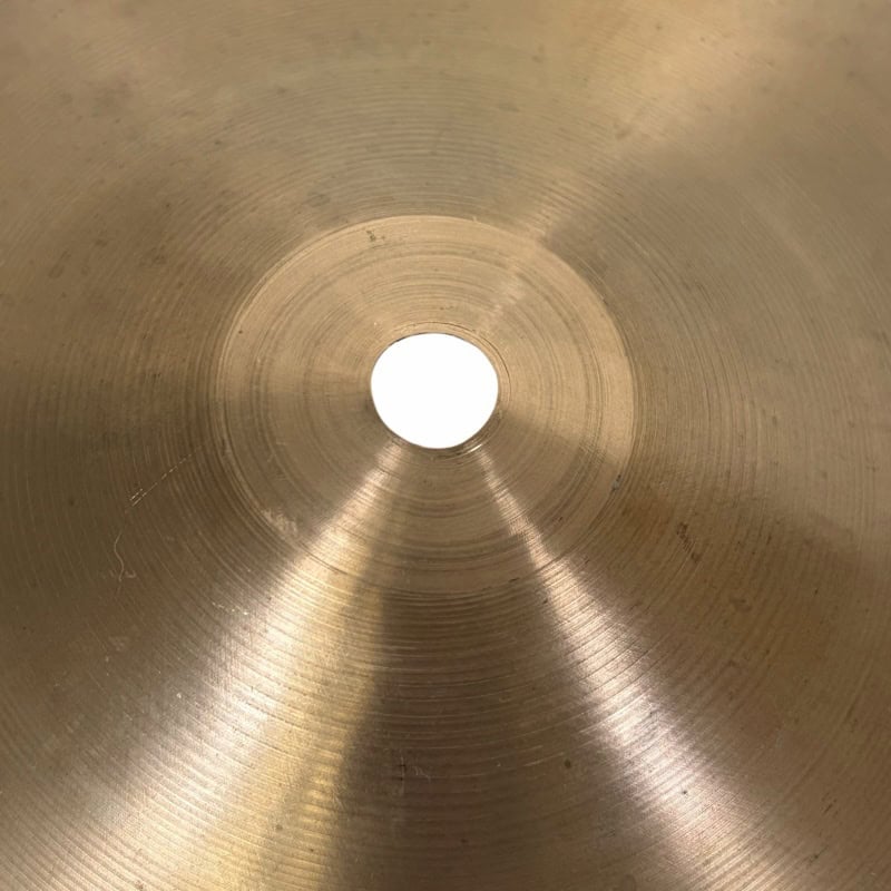 Cymbal hole close-up, highlighting the metallic surface and concentric circles of a professional dru.
