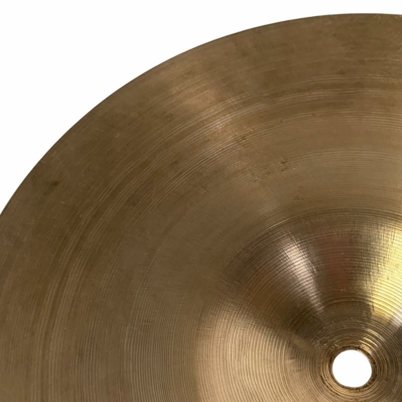 Brass cymbal for drums, detailed surface, used in percussion, musical instrument, studio shot.
