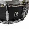 Black snare drum with chrome tension rods and badge, close-up shot highlighting drum details.