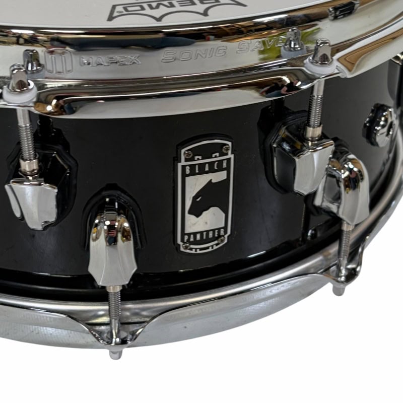Black drum kit with Drummers Only logo, close-up of drum hardware and badge.